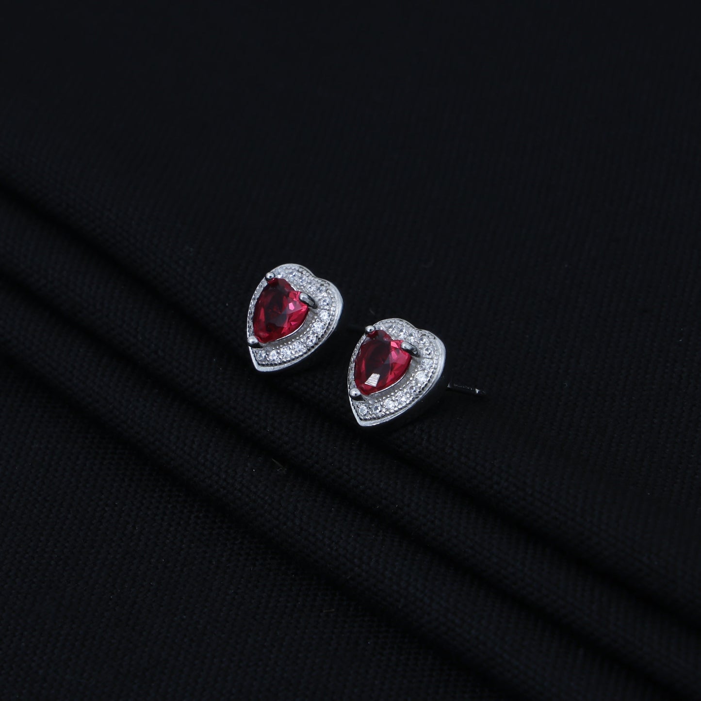 Stylish heart-shaped silver earrings adorned with pink and white stones