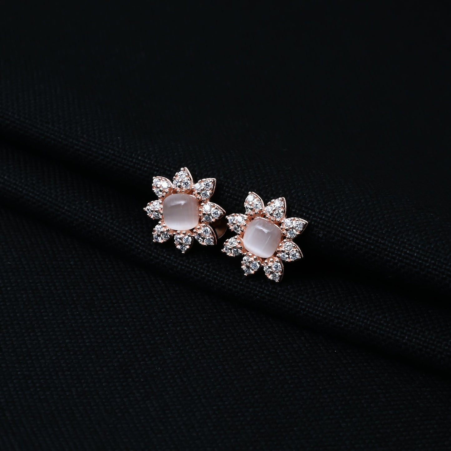 Stylish silver stud earrings with a flower motif and pearl centerpiece