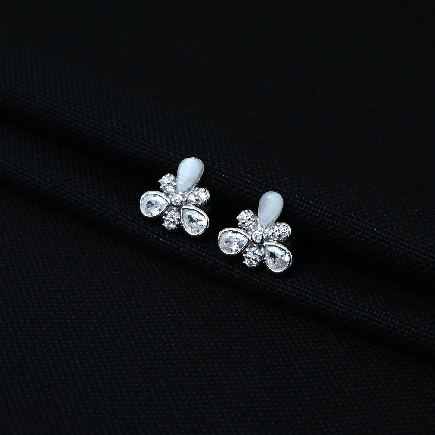 Stylish sterling silver earrings with a floral motif, opal, and gemstone accents