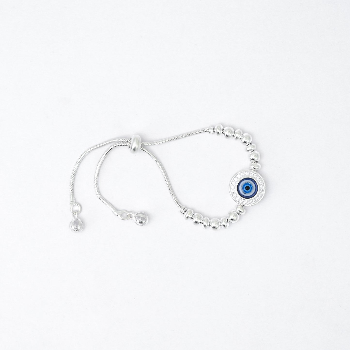 Elegant silver bracelet adorned with evil eye stone and floral design.