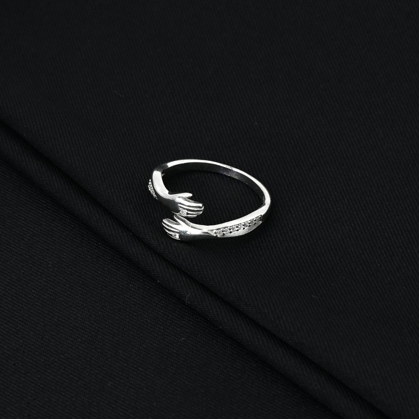 Elegant silver hug ring with sparkling white stones for a chic look.