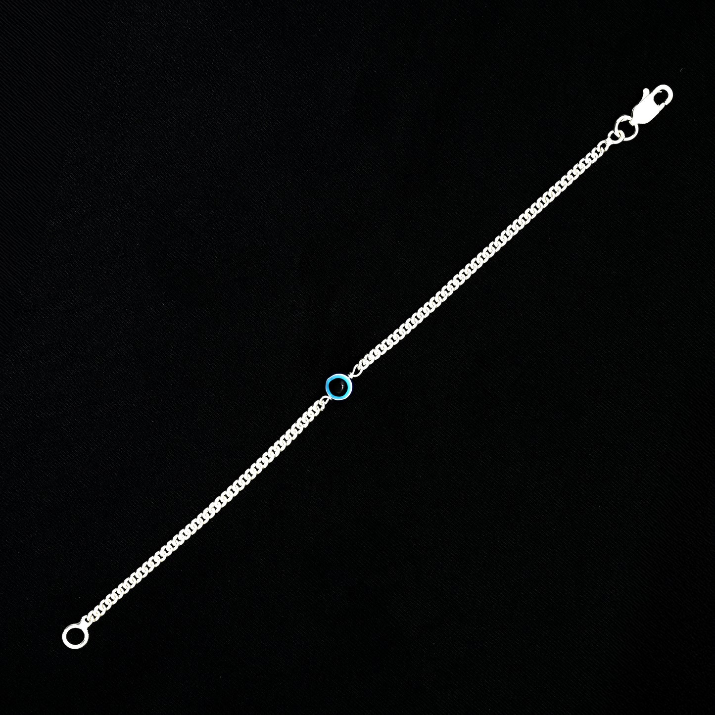 Fashionable silver bracelet with blue evil eye for a protective look.