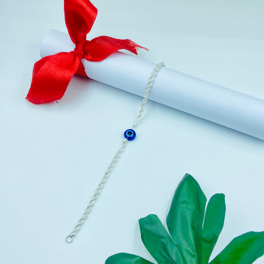 Charming silver bracelet with evil eye charm for protection.