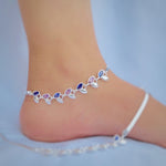 Load image into Gallery viewer, Silver anklet featuring blue and pink stones, leaf patterns, and buds.