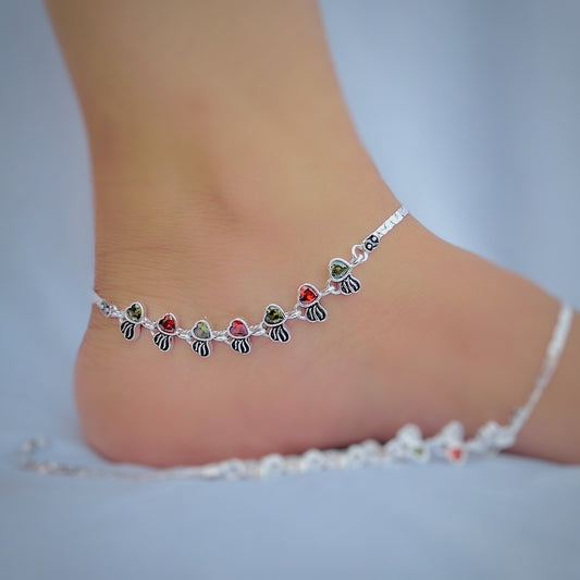Elegant silver anklet featuring red and green heart-shaped stones.
