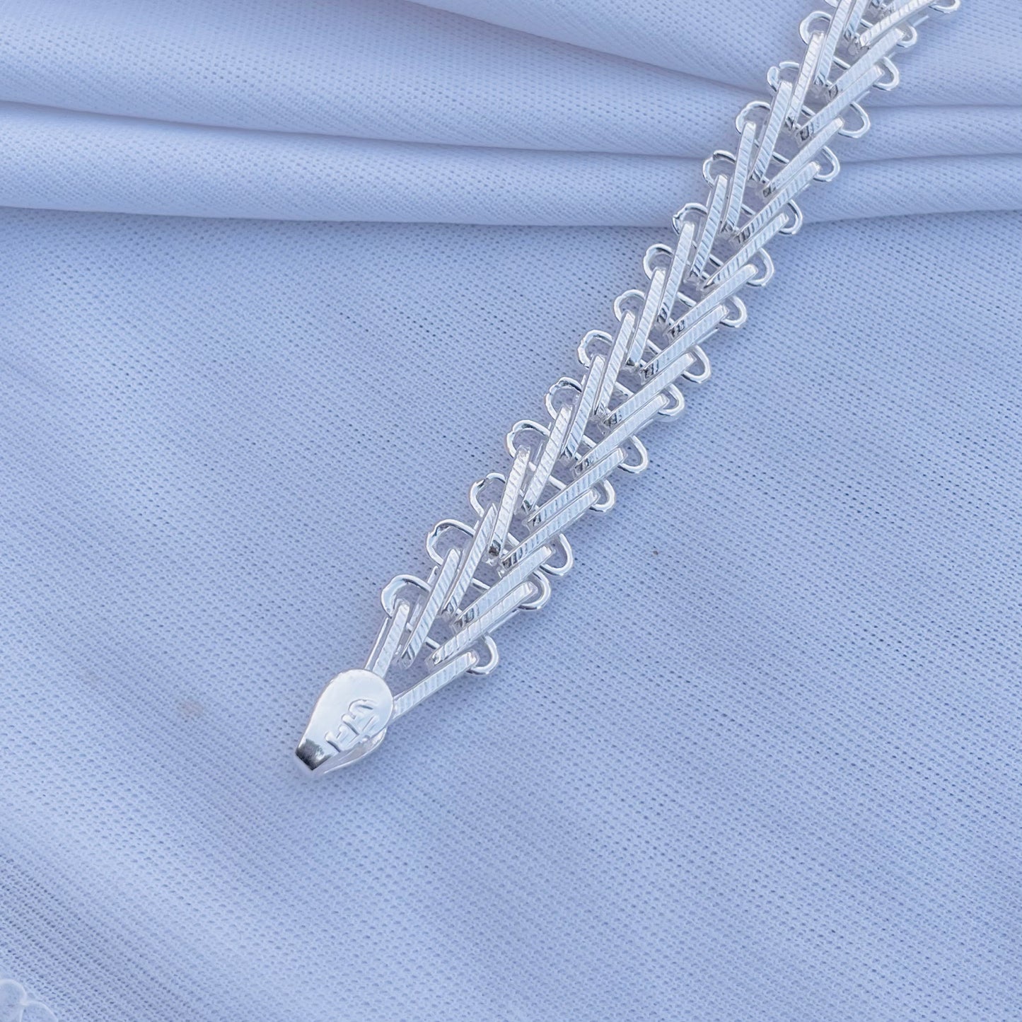 Silver bracelet with unique link design, ideal for a bold style.