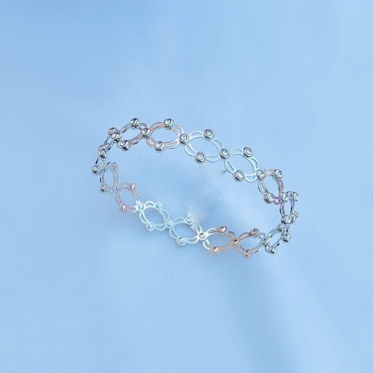 Convertible silver bracelet to ring, perfect for versatile styling.