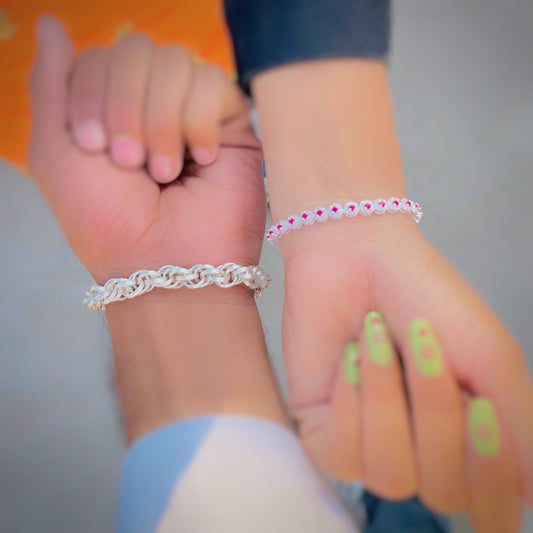 Elegant silver bracelet set with curly chain for boys and pink stone bracelet for girls.
