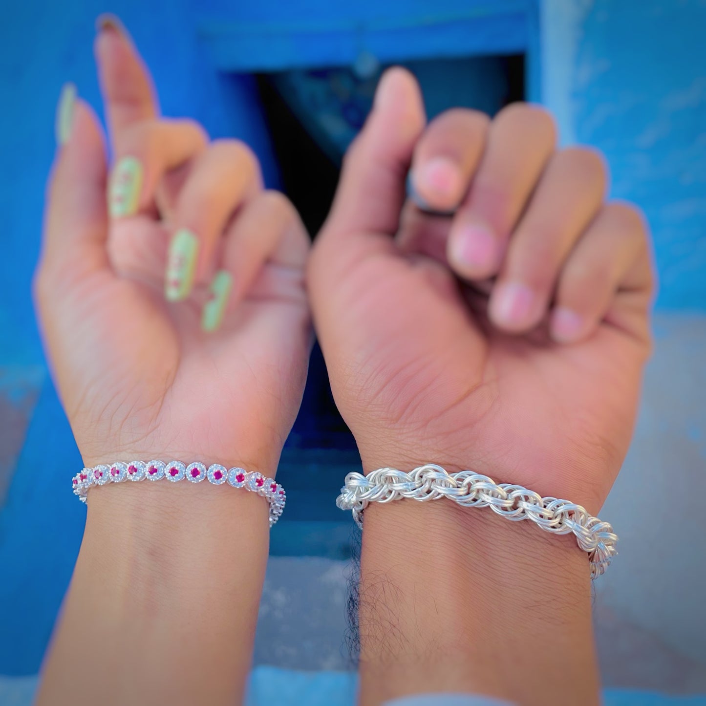 Trendy silver bracelet set with boy's curly chain and girl's pink stone accent.