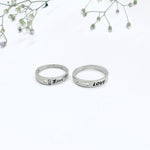 Load image into Gallery viewer, Unique Silver Couple Rings with Romantic "Love" Text at the Core.
