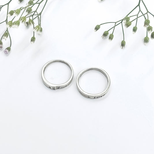 Unique Silver Couple Rings with Romantic "Love" Text at the Core.