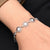 Silver bracelet featuring a flower-shaped ring charm, designed for girls.