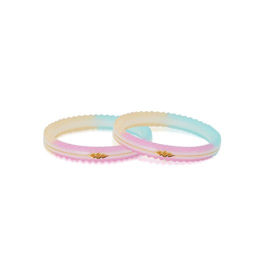 Gold bangle with a light, colorful small swastika design.