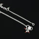 Beautiful silver anklet adds charm with its colorful gems and love motif.