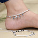 Anklet for girls featuring silver sea shells and black beads.