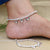 Girls' silver anklet featuring lotus and beads.