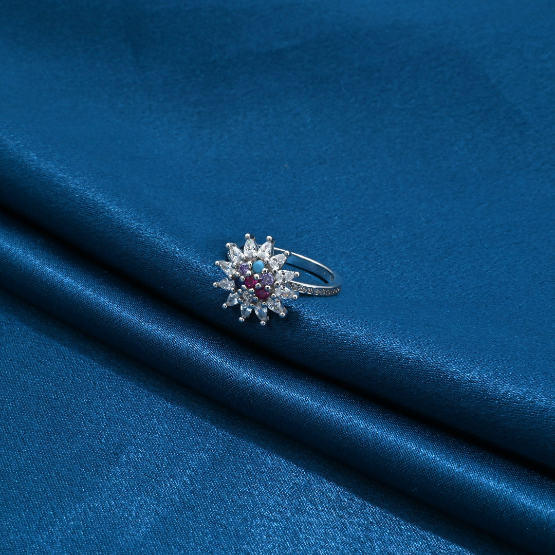 Silver ring with white stones and vibrant colorful centerpiece design.