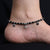 Elegant sterling silver anklet with black beads and ghungroo details.