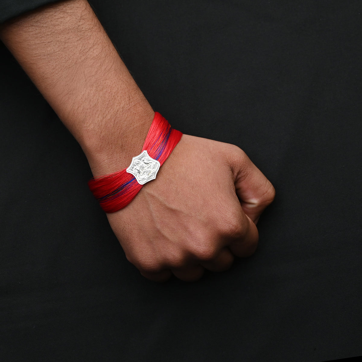 Silver dhaga moli with royal symbol in center