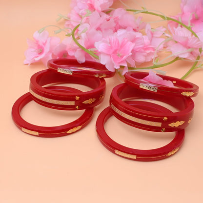 Red Gold Bangle Set Featuring Swastika Design – Stylish & Cultural.