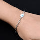 Elegant silver bracelet with evil eye charm, designed as a minimalist protection piece.