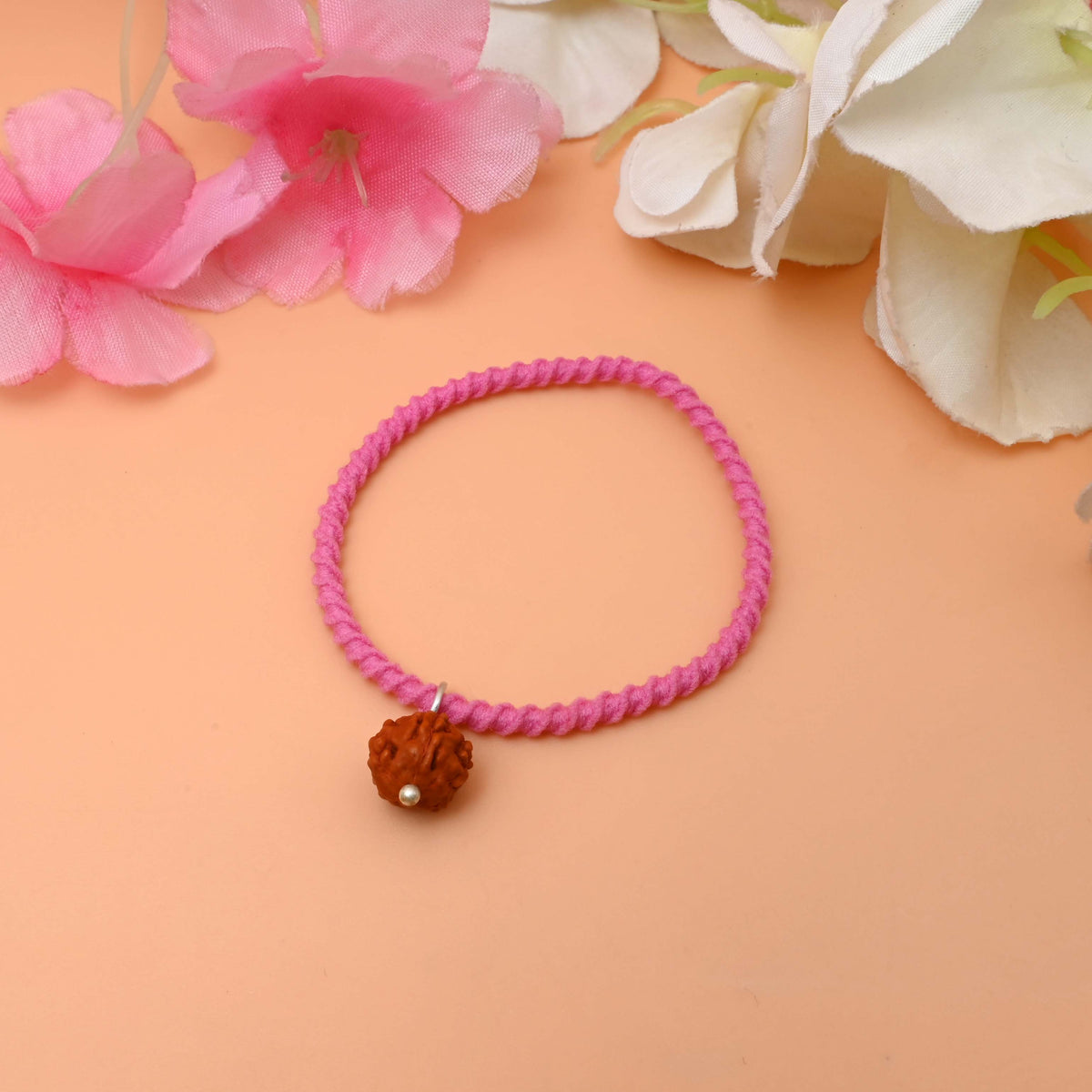 An elegant bracelet adorned with a small rudraksha