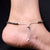 Silver anklet adorned with aqua blue heart charm.