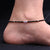 Girls' silver anklet featuring evil eyes and black beads.