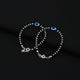 Stylish silver bracelet showcasing an oval evil eye design with black beads.