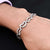 Elegant bracelet featuring designer half-moon charms and CZ studs in sterling silver.