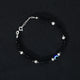 Stylish sterling silver bracelet adorned with black beads and an evil eye charm.