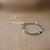 Girls' silver anklet with heart and evil eye.