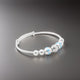 Charming sterling silver baby kada with blue and beige beads.