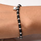 Elegant silver bracelet featuring a cat design and black bead accents for girls.