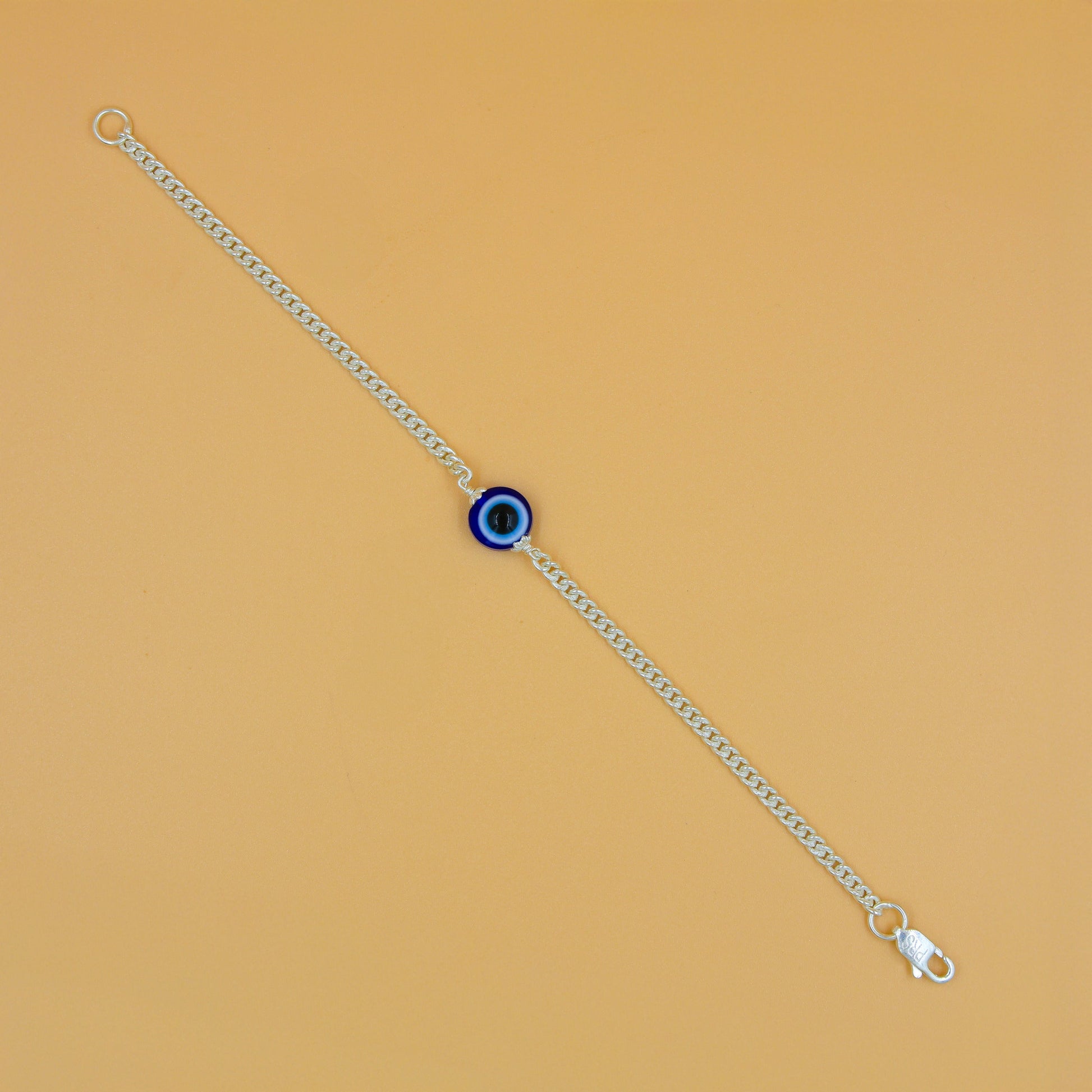 Elegant silver chain bracelet adorned with a striking blue evil eye