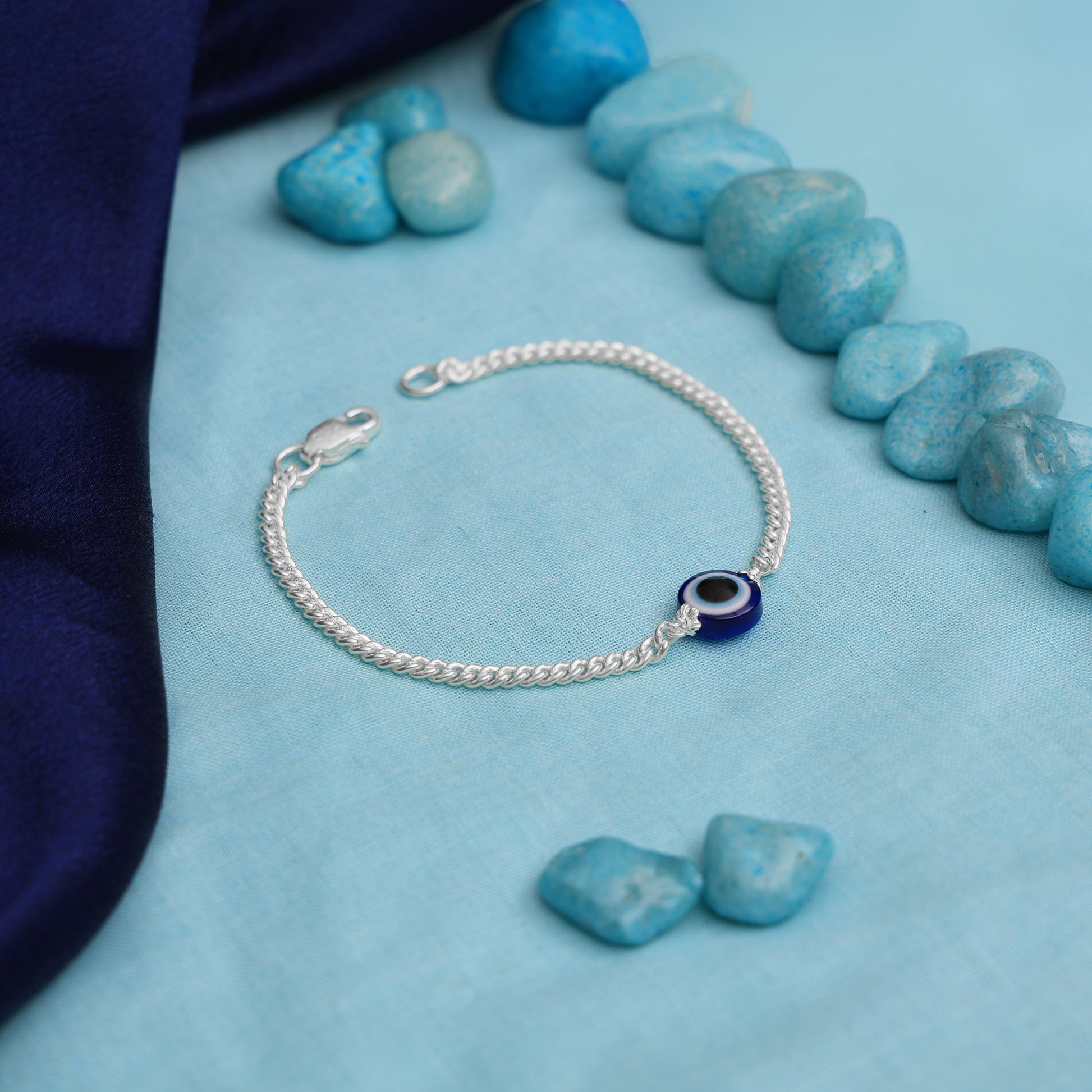 Stylish silver bracelet with a blue evil eye charm for protection