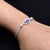 Stylish silver bracelet with a blue evil eye design in the center, tailored for boys.