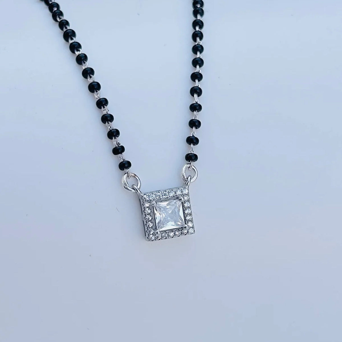 Black beaded mangalsutra featuring sparkling square pendant