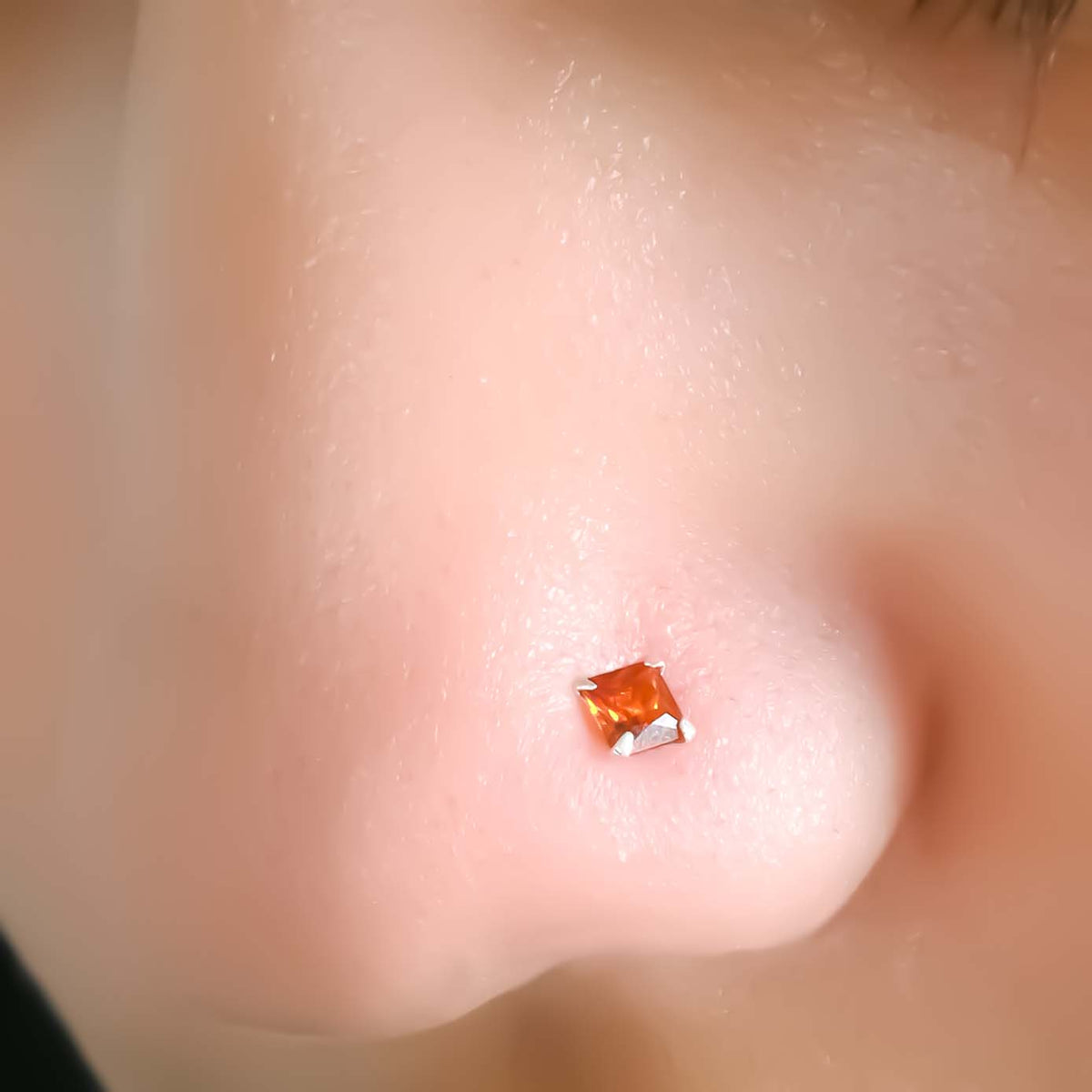 Modern silver nosepin with red gem