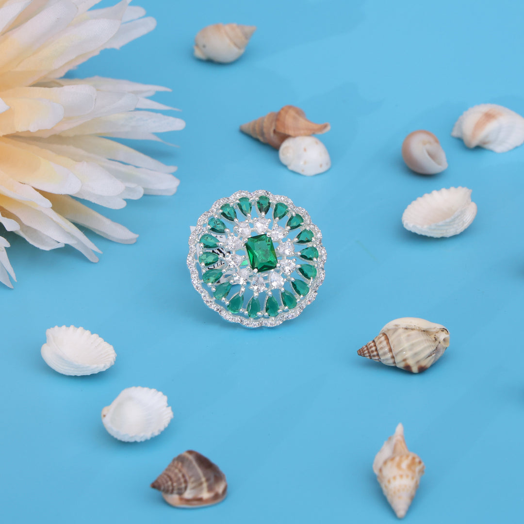 Silver ring for women featuring green mini stones and a stunning center gemstone.