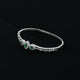 Stylish silver bracelet showcasing a green oval-shaped gemstone, tailored for girls.