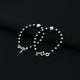 Stylish silver bracelet adorned with black beads and a prominent central silver bead.