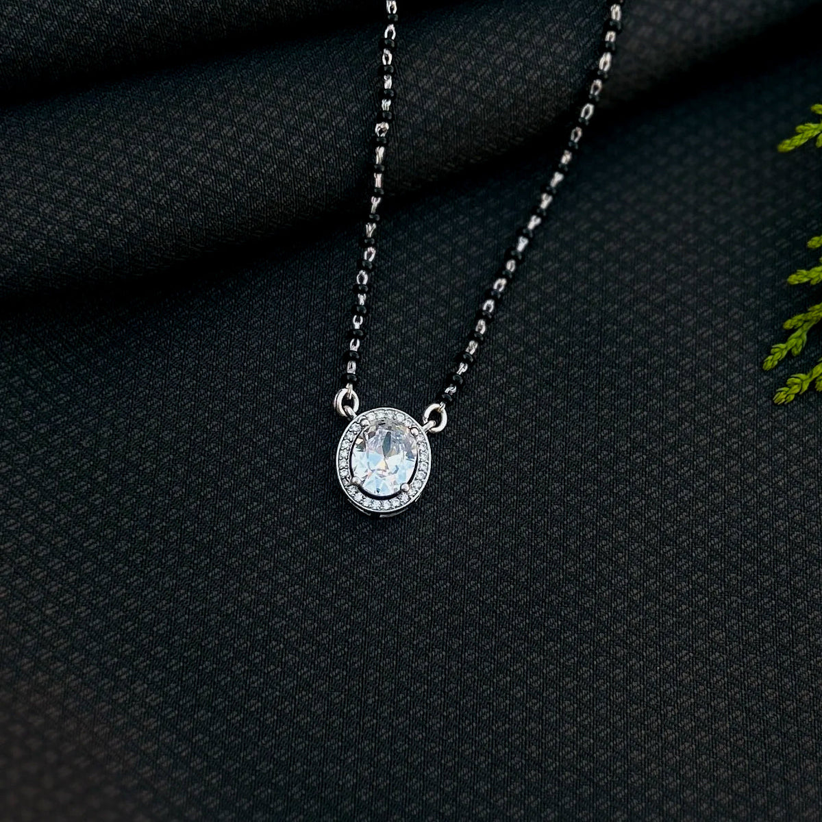 Black beads mangalsutra featuring oval shaped stone pendant