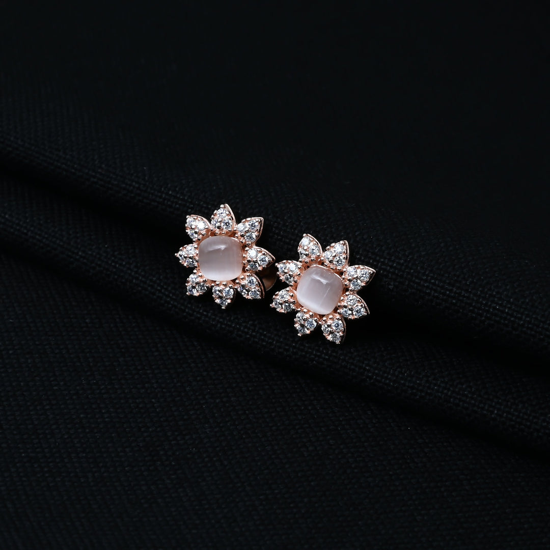Stylish silver stud earrings with a flower motif and pearl centerpiece
