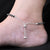 Silver anklet with heart and protective evil eye.