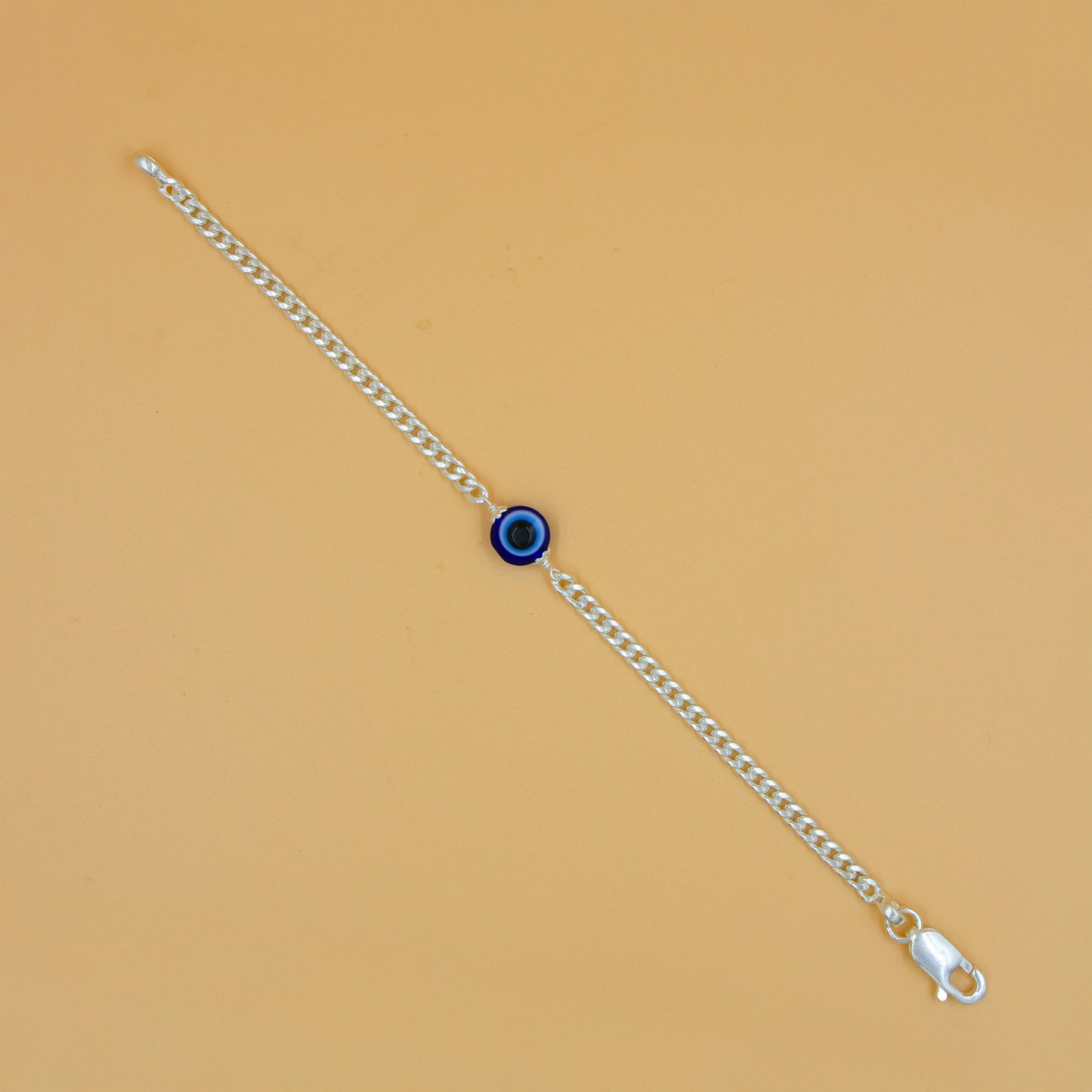 Stylish silver chain bracelet adorned with a detailed evil eye charm