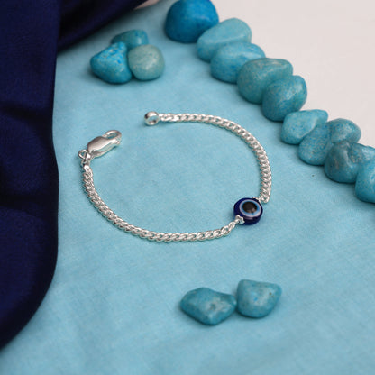 Silver chain bracelet featuring a protective evil eye charm