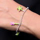 Stylish silver bracelet showcasing a green star and pink flower motif.