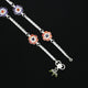 Elegant anklet enhances outfits with playful and tempting flower motifs.