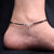 Elegant silver anklet with black beads and evil eyes for girls.